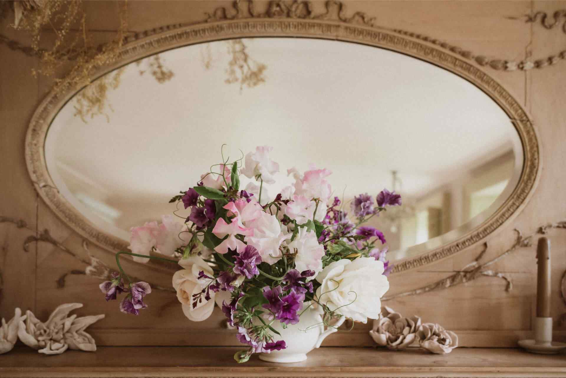 Purple and white flowers in a bone china teapot by Duchess China with a Halliesphere flower arranger