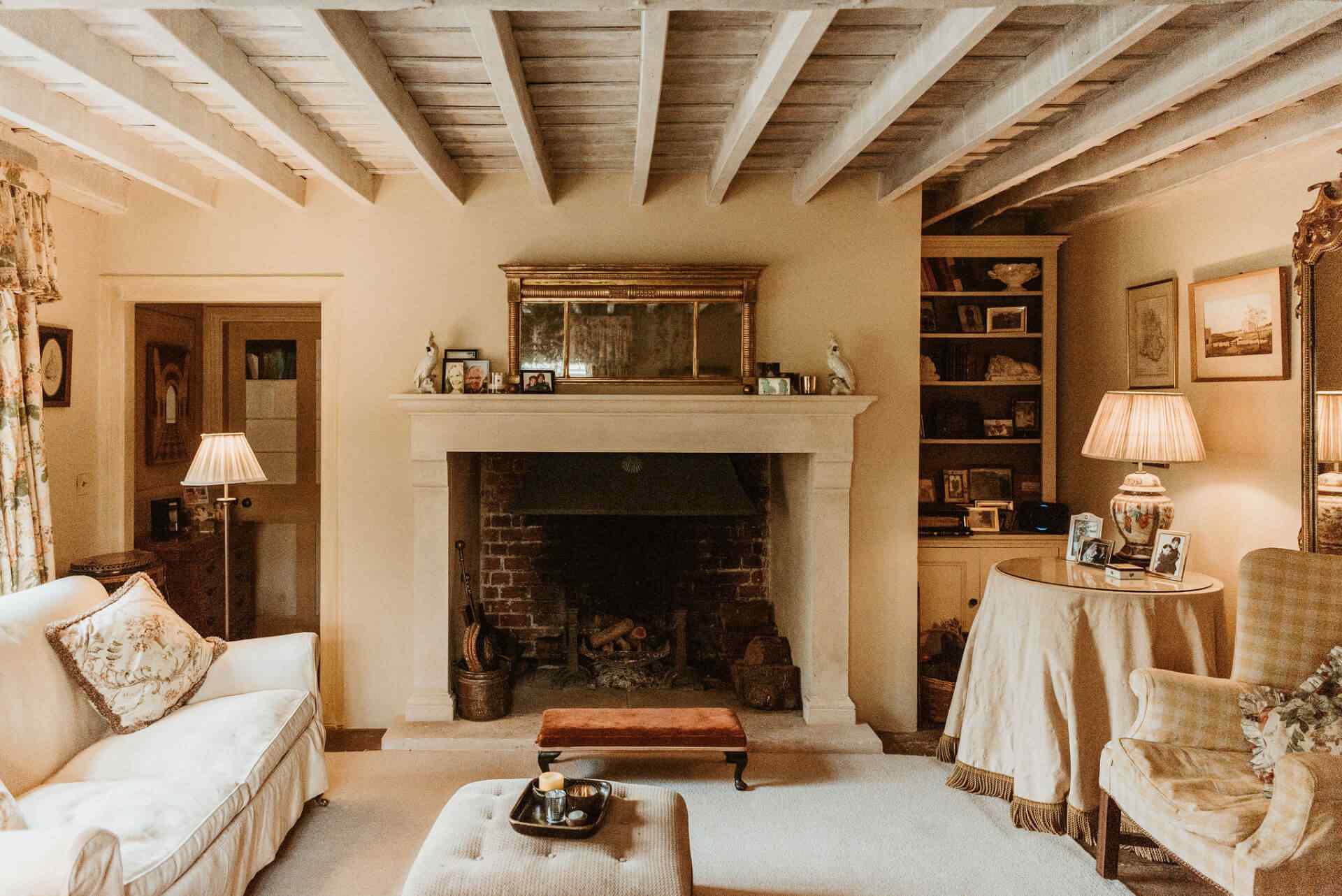 Period living room with fireplace and exposed beams