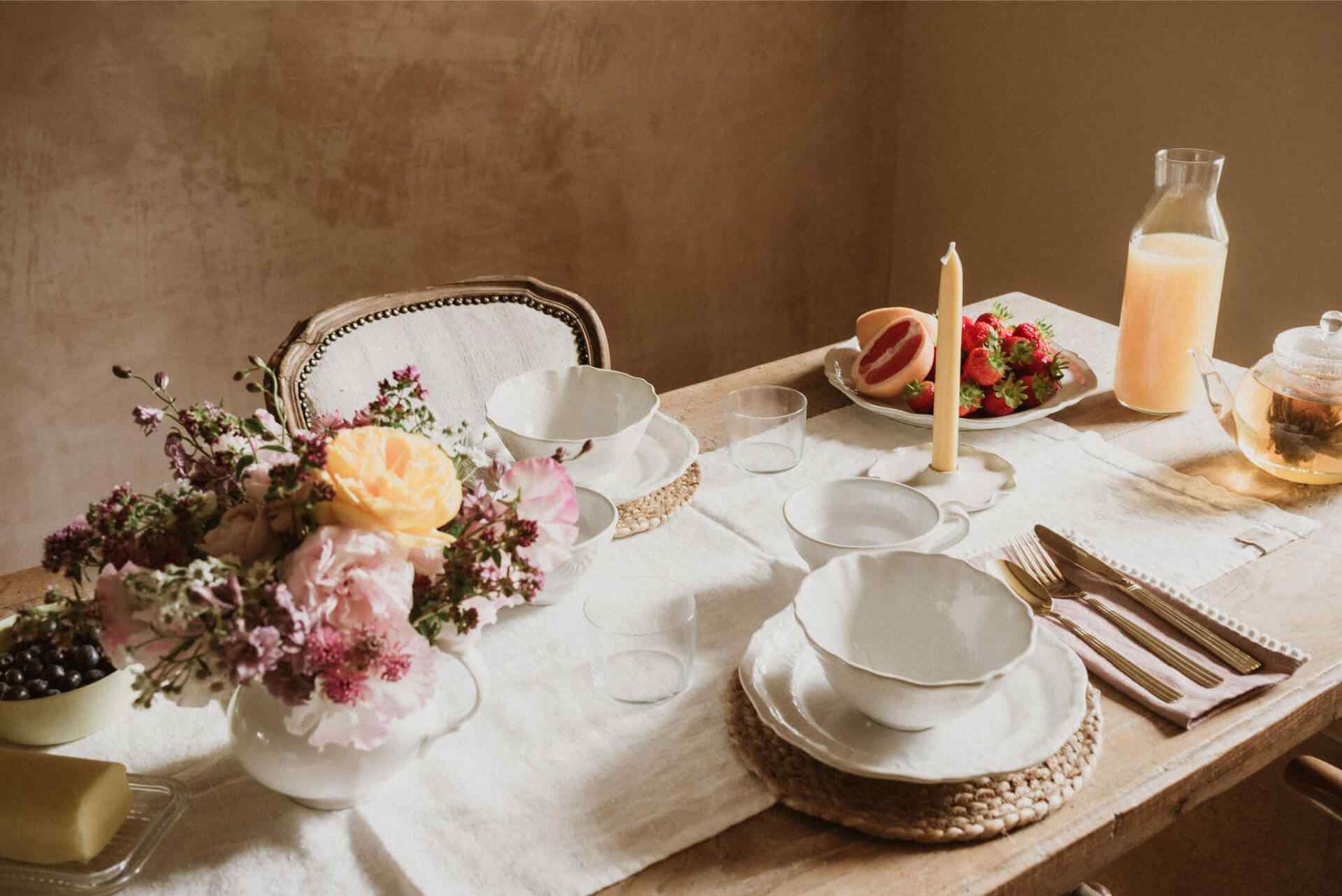 A table laid with tableware from Sorbet Living and flowers arranged with a Halliesphere